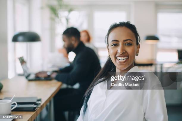 portrait of happy businesswoman in co-working space - incidental people stock pictures, royalty-free photos & images