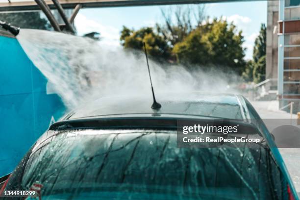 car washing. cleaning car using high pressure water. - car splashing water on people stock pictures, royalty-free photos & images