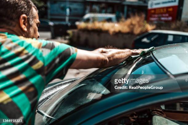 mature man washing car windshield - microfiber towel stock pictures, royalty-free photos & images