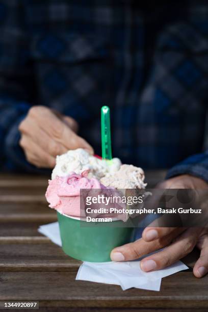 a man eating ice cream - ice cream cup stock-fotos und bilder