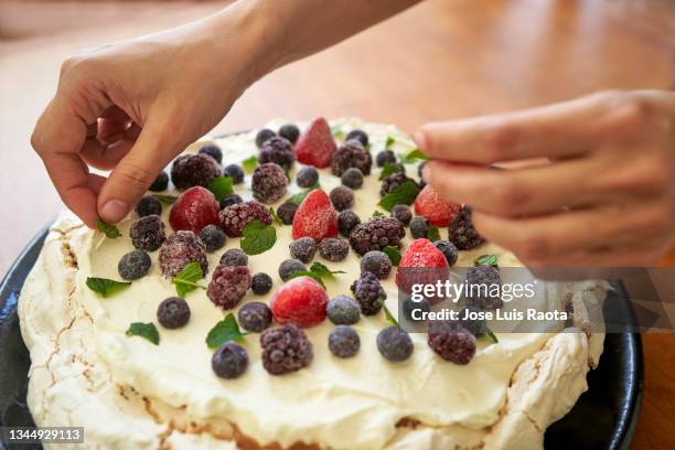 closeup of pavlova cake, decorated with fresh strawberries, blackberries, blueberries and cherry. - make room make room stock pictures, royalty-free photos & images