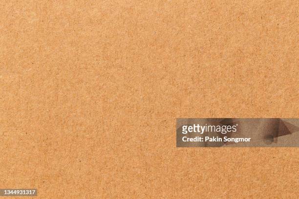 brown color eco recycled kraft paper sheet texture cardboard background - kraft paper stockfoto's en -beelden