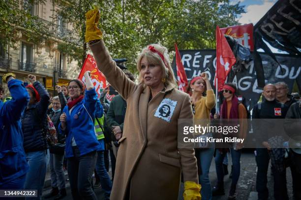 British actress Joanna Lumley joins protestors dressed as the icon Rosie the Riveter as they march through the streets of Paris demonstrating over...