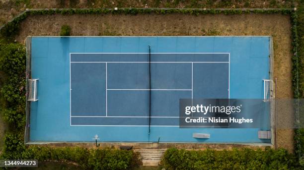 aerial photo looking directly down on a tennis court in cascais, portugal - tennis court stock pictures, royalty-free photos & images