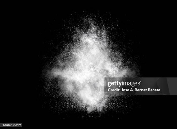 white smoke and dust explosion on a black background. - dust stock pictures, royalty-free photos & images