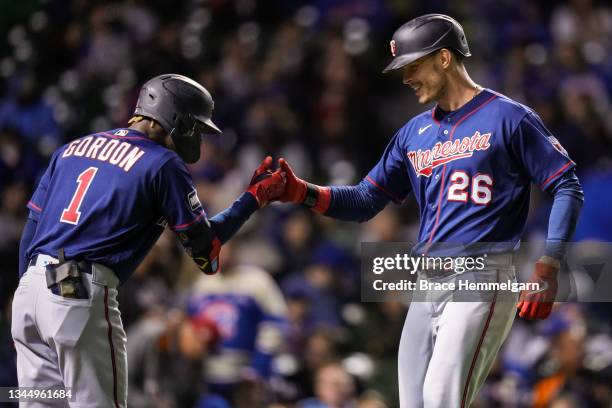 Max Kepler of the Minnesota Twins celebrates his home run with Nick Gordon against the Chicago Cubs on September 22, 2021 at Wrigley Field in...