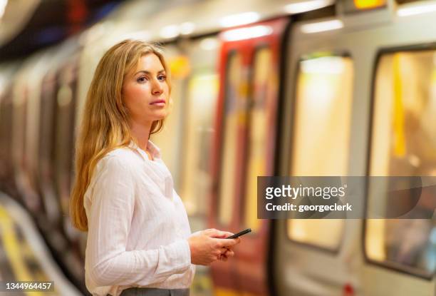 waiting to get on the tube train - london underground train stock pictures, royalty-free photos & images