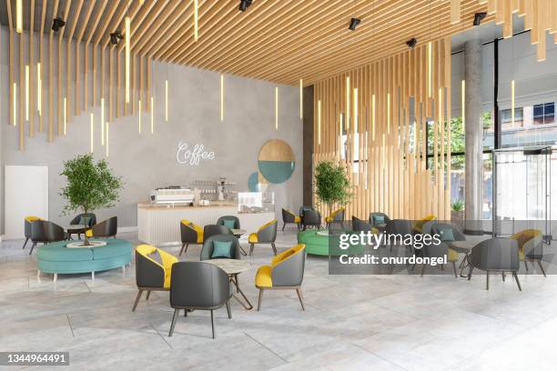 interior de cafetería con sillones de cuero, mesas redondas y luces colgantes - hotel ecologico fotografías e imágenes de stock