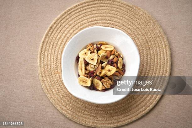 healthy granola for breakfast with berry fruit nut. dried fruits and nuts top view background - trail mix stock pictures, royalty-free photos & images