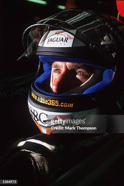 Team Jaguar Driver Eddie Irvine of Northern Ireland relaxes in the garge during the Formula One Hungarian Grand Prix held at the Hungaroring Circuit,...