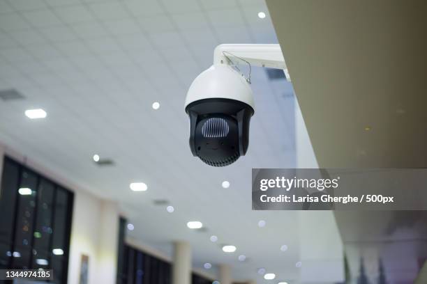 low angle view of illuminated lighting equipment hanging from ceiling - security camera view stock pictures, royalty-free photos & images