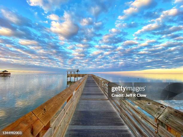 clouds over the south padre island boardwalk - ilha south padre imagens e fotografias de stock
