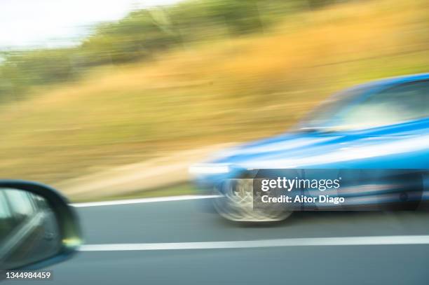 a car is traveling at high speed on the road. shaken image. - frozen and blurred motion stock pictures, royalty-free photos & images