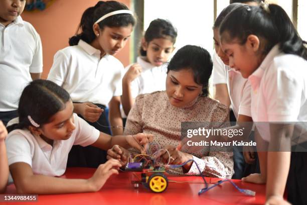 school girls making wiring connections in a  robot model car in school - all india students association stock pictures, royalty-free photos & images