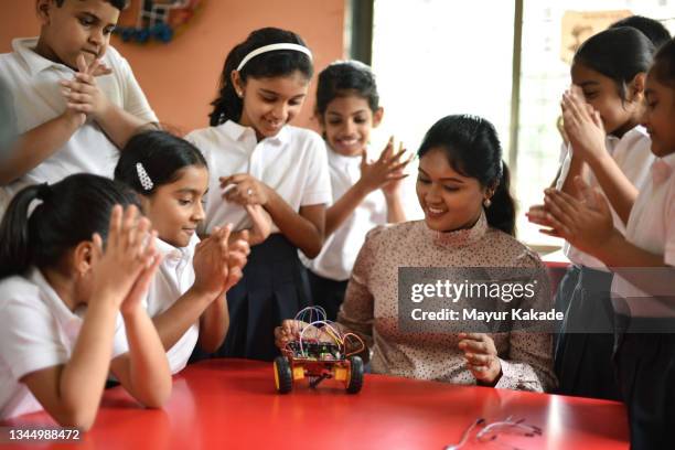 happy teacher and students claps as their robotic car model  successfully works - stem assunto imagens e fotografias de stock