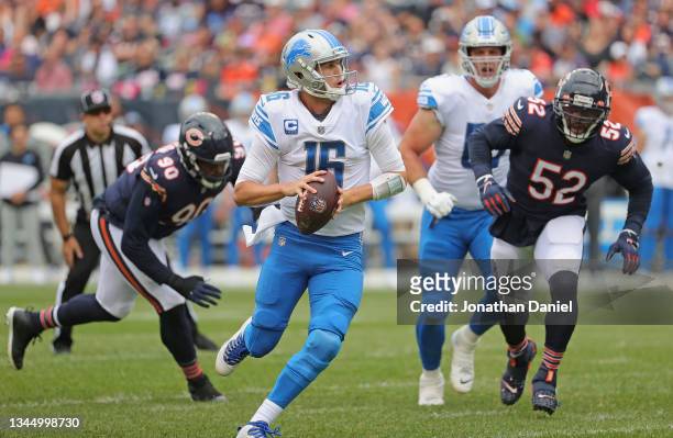 Jared Goff of the Detroit Lions looks for a receiver chased by Angelo Blackson and Khalil Mack of the Chicago Bears at Soldier Field on October 03,...