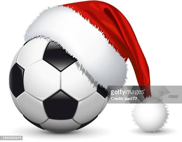 weihnachtsmannhut auf fußball - christmas and football stock-grafiken, -clipart, -cartoons und -symbole