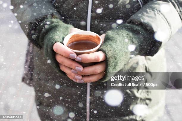 midsection of woman holding coffee cup during winter - fingerless glove stock pictures, royalty-free photos & images