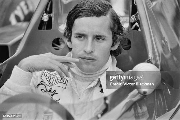 Belgian Formula One racing driver Jacky Ickx in the cockpit of his Ferrari car at the Silverstone Circuit near the village of Silverstone,...