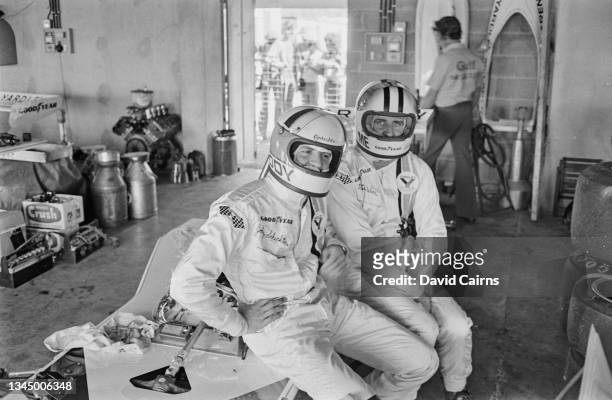 South African motor racing driver Jody Scheckter and his McLaren teammate, New Zealand motor racing driver Denny Hulme , sitting in the McLaren...