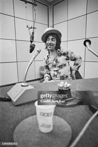 British drummer Keith Moon , of the British rock band The Who, wearing a floral pattern shirt and a straw boater during a BBC Radio interview in a...