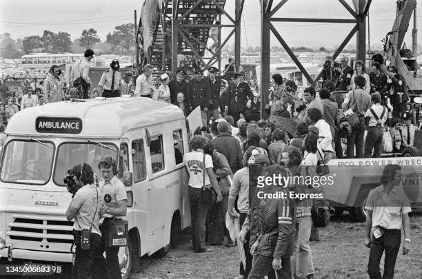 Crowd gathers as an ambulance attends the scene of Italian motor racing driver Andrea de Adamich's crashed Brabham BT42 during the British Grand Prix...