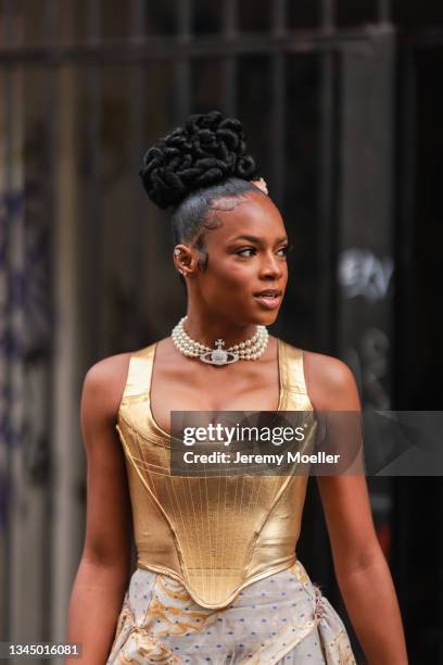 Didi Stone wearing a gold vivienne westwood top and skirt outside Vivienne Westwood on October 02, 2021 in Paris, France.