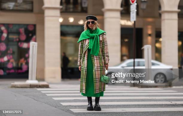 Karin Teigl wearing a Burberry coat, gucci shades and a chanel bag on October 02, 2021 in Paris, France.