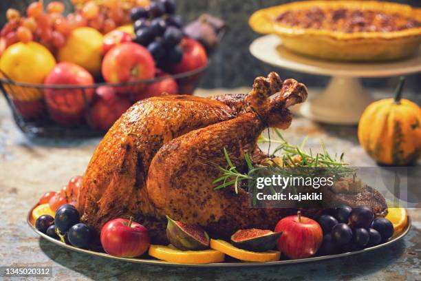 preparing stuffed turkey with side dishes for holidays - banket stockfoto's en -beelden