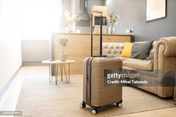 modern suitcase placed in living room - bagaglio foto e immagini stock