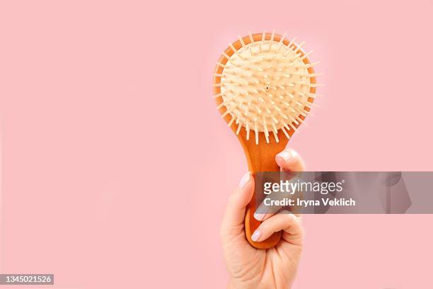 woman hands holding natural bamboo wooden comb brush. routine step for healthy skin and hair care. - hairbrush 個照片及圖片檔