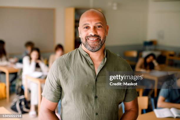 portrait of smiling male professor in classroom - hispanic man foto e immagini stock