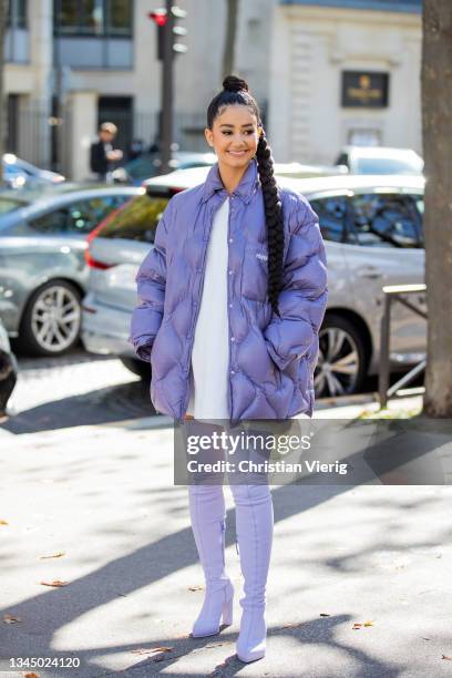 Lena Situation seen wearing purple down feather jacket, overknees boots, white dress outside Miu Miu during Paris Fashion Week - Womenswear Spring...