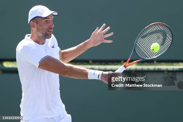 Ivo Karlovic of Croatia returns a shot to Brayden Schnur of Canada during qualifying for the BNP Paribas Open at the Indian Wells Tennis Garden on...