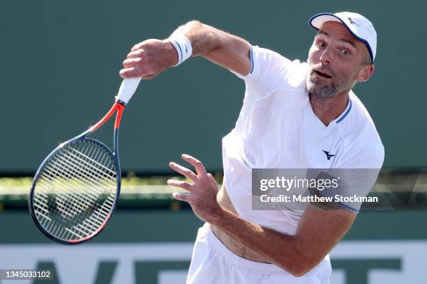 Ivo Karlovic of Croatia serves to Brayden Schnur of Canada during qualifying for the BNP Paribas Open at the Indian Wells Tennis Garden on October...