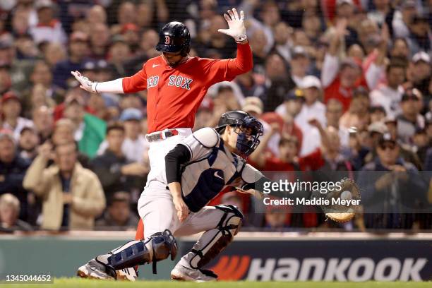 Xander Bogaerts of the Boston Red Sox scores a run past Kyle Higashioka of the New York Yankees during the sixth inning of the American League Wild...