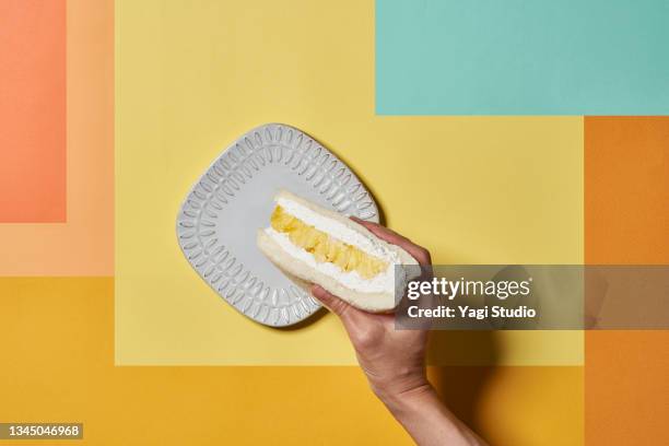 fruit sandwiches on a colorful background. - plate in hand stockfoto's en -beelden