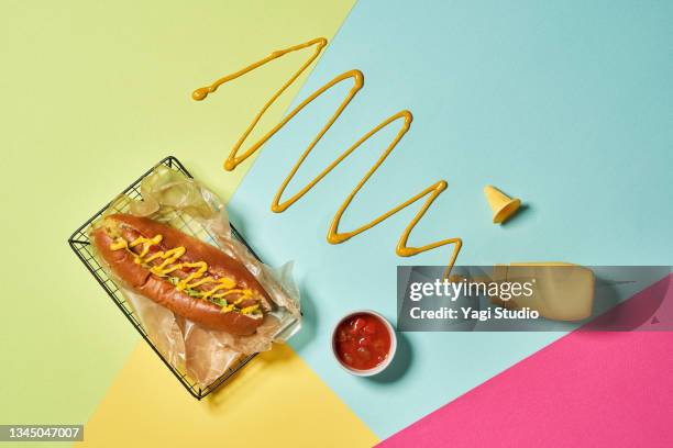 hotdog on a colorful background. - sauce stock pictures, royalty-free photos & images