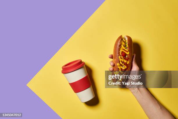 hot dogs and reusable cup on a colorful background. - asian eating hotdog stock pictures, royalty-free photos & images