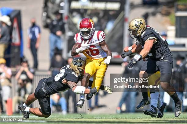 Wide receiver Tahj Washington of the USC Trojans is hit by safety Isaiah Lewis of the Colorado Buffaloes in the first quarter of a game at Folsom...