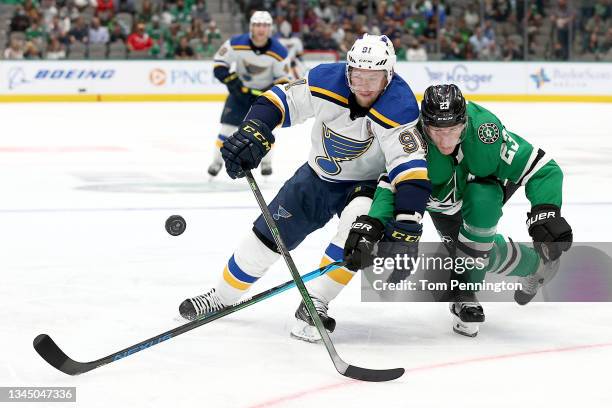 Vladimir Tarasenko of the St. Louis Blues battles for the puck against Esa Lindell of the Dallas Stars in the second period of a NHL preseason game...