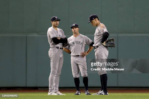 Joey Gallo, Brett Gardner and Aaron Judge of the New York Yankees stand in the outfield during a pitching change against the Boston Red Sox during...