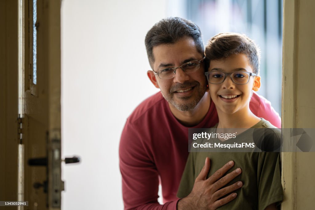 Portrait father and son smiling looking at the camera