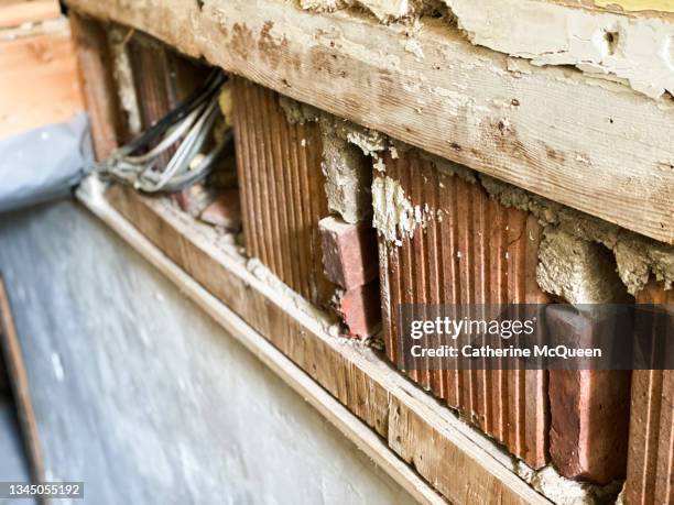 removal of drywall along staircase leading to house basement during mold remediation after flood - souterrain stockfoto's en -beelden