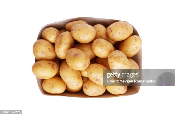 potatoes in paper box isolated in white background - rå potatis bildbanksfoton och bilder