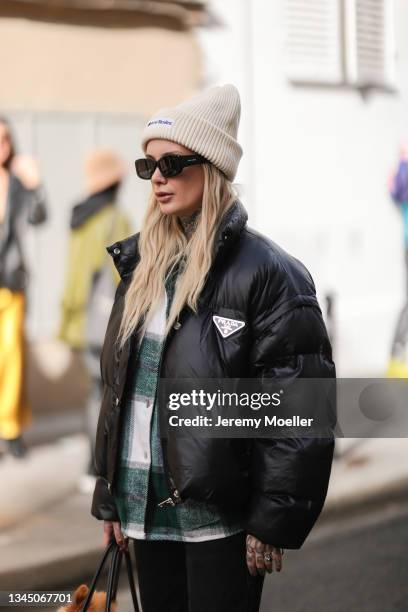 Valentina Belleza wearing a beige acne studios cap, a prada jacket and a plaid shirt outside Vivienne Westwood on October 02, 2021 in Paris, France.