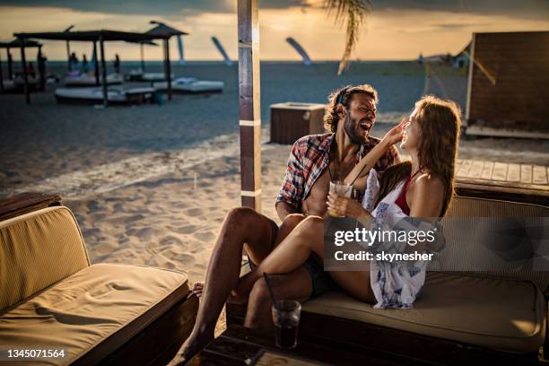 cheerful couple talking while enjoying in beach bar. - cafe at beach bildbanksfoton och bilder