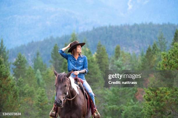 woman riding her horse at a ranch - western canada farm stock pictures, royalty-free photos & images