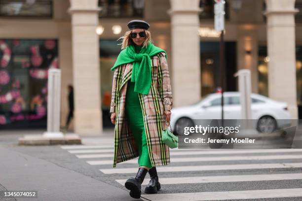 Karin Teigl wearing a Burberry coat, gucci shades and a chanel bag on October 02, 2021 in Paris, France.