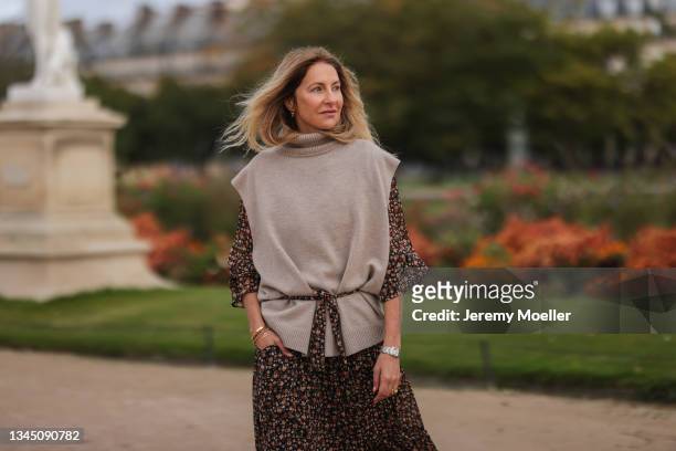 Sue Giers wearing a beige pullunder, a floral maxi dress on October 02, 2021 in Paris, France.